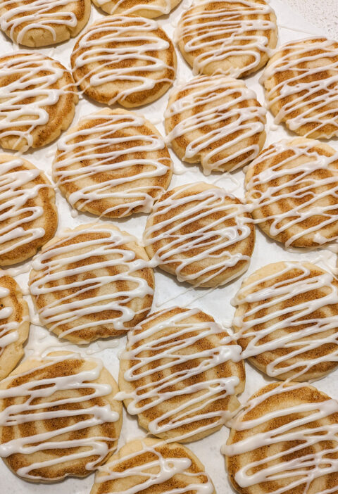 Rows of frosted cinnamon cookies side by side.