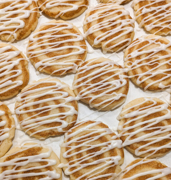 Rows of frosted cinnamon cookies side by side.